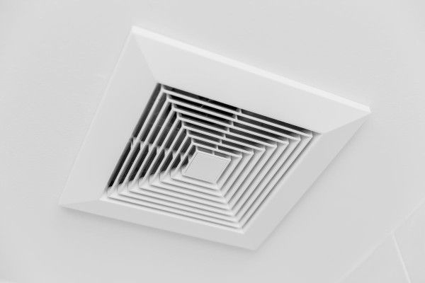 Ducted air conditioning system on the ceiling of a home.