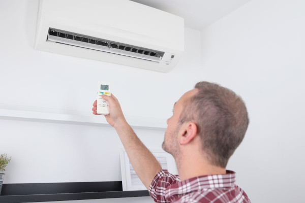 Australian man trying to turn on his air conditioner system, which is short-cycling.