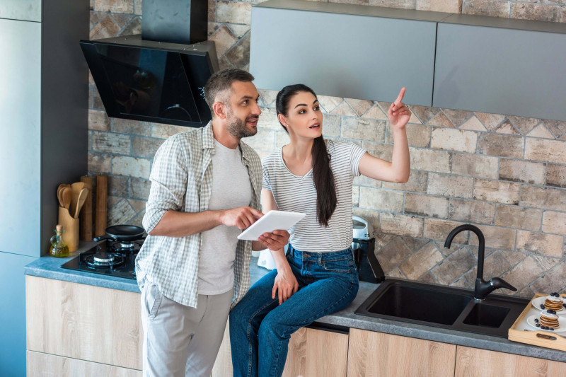 couple using an izone system in their home